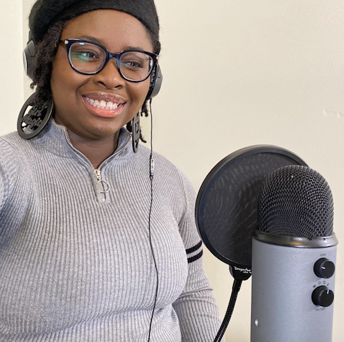 Ariel D. Smith, The Food Truck Scholar in front of a microphone