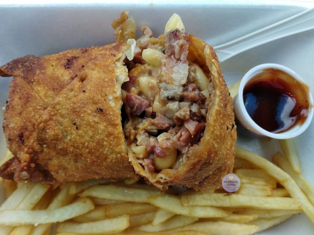 The Brisket Mac stuffed eggroll with barbecue sauce and shoestring fries. From Saucy Nosh, a Black food truck.