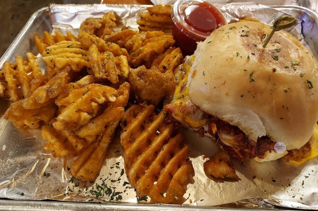 Pulled Smoked Turkey Sandwich with waffle fries from Turkey Leg Hut.