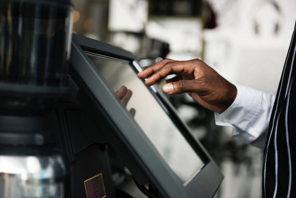 Food truck cashier entering an order into the point of sale system.