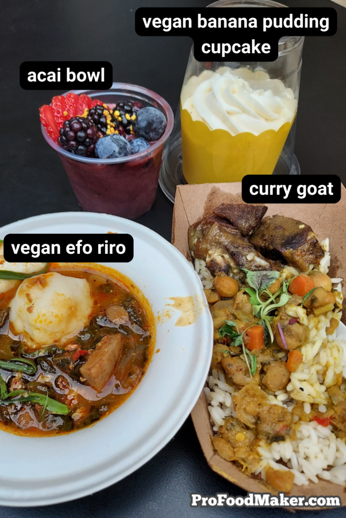 post houston events food festival. Acai bowl, vegan banana pudding cupcake, vegan efo riro and curry goat on a black table.