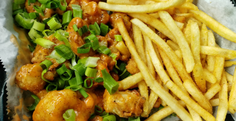 vegan restaurants houston near me. This is the buffalo cauliflower wings with shoestring fries from Mo Better Brews vegan brunch spot.