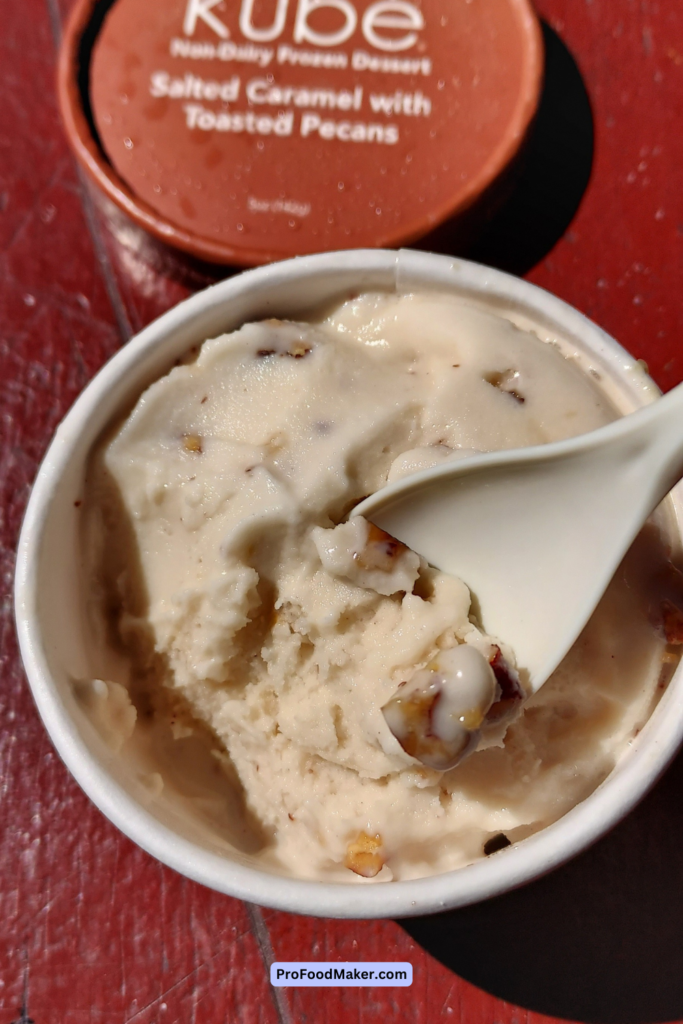 vegan ice cream oakland. Close up shot of ice cream with pecans on plastic spoon.