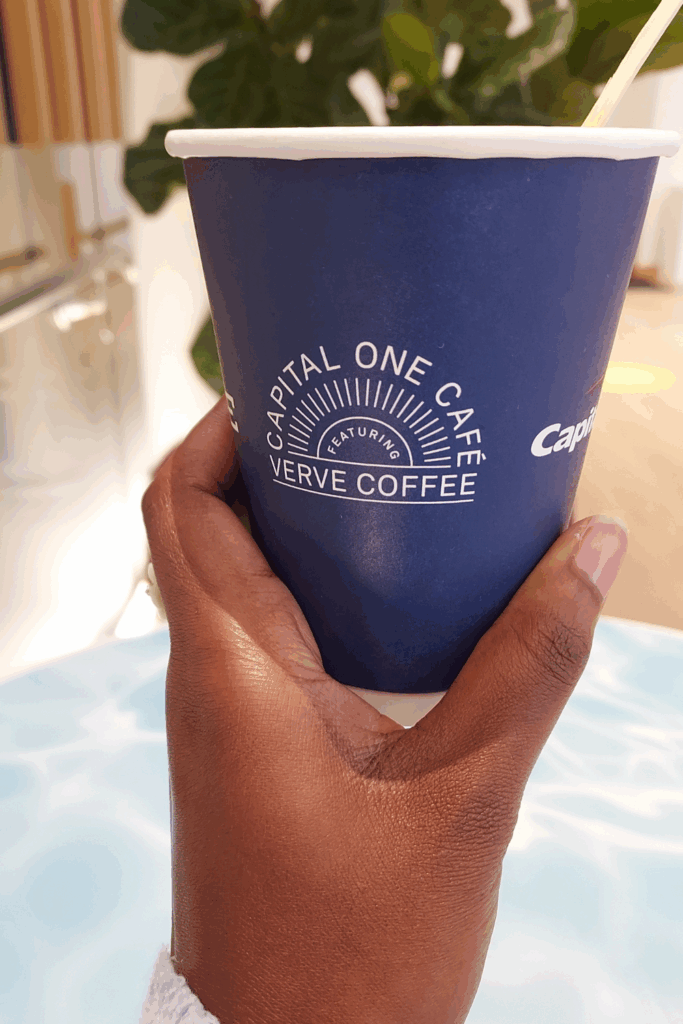 Capital One Cafe menu item: Honey lavender latte in a dark blue paper cup.