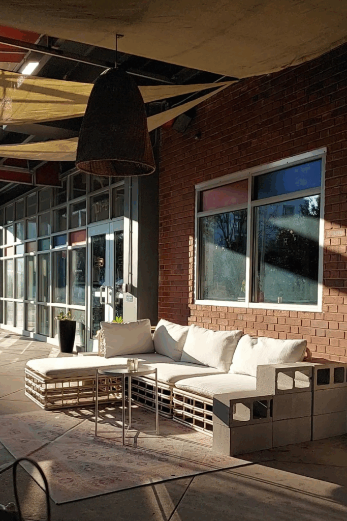 lorem ipsum charlotte. This is the outdoor space of the bar that has several tables and a sofa with a chaise lounge.