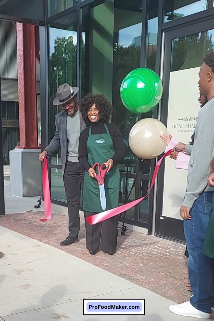 Cherisse Byers cutting the red ribbon in front of Hone Sharpen