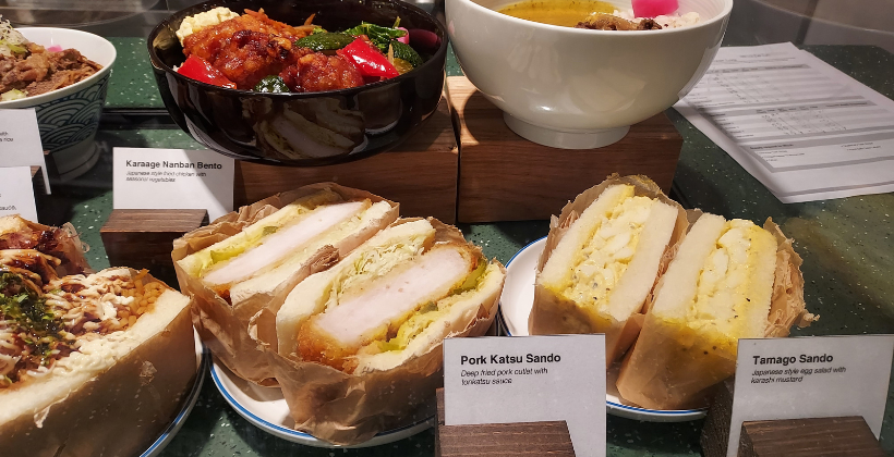 Tamago sandwich, pork katsu sando and yakisoba sandwich in a display case at Muji Market