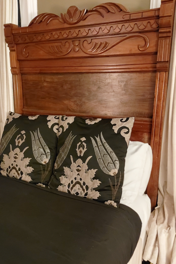 wood victorian headboard close up photo