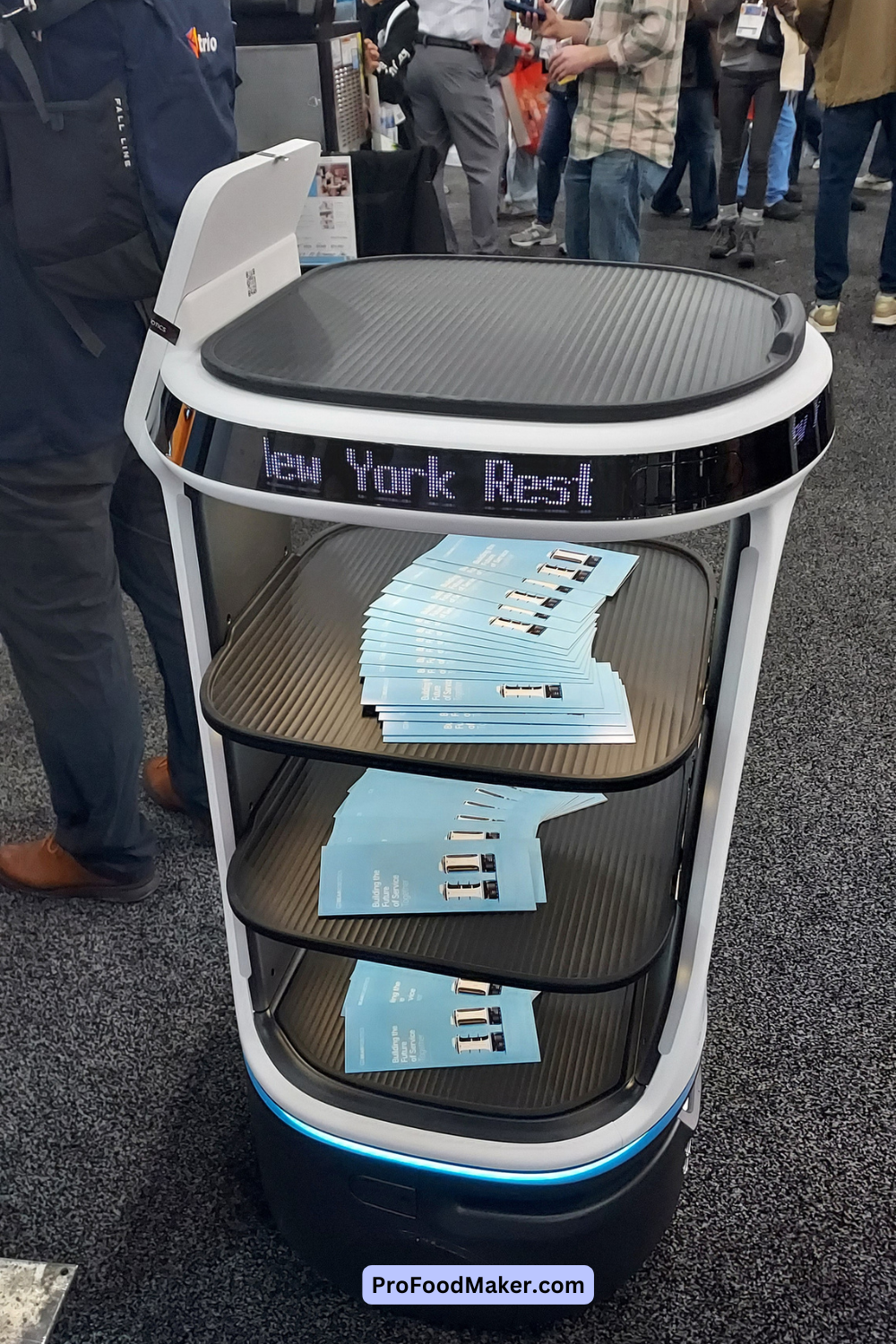 Bear Robotics Servi+ model. It's the newest one and it's holding several pamphlets on each tray.