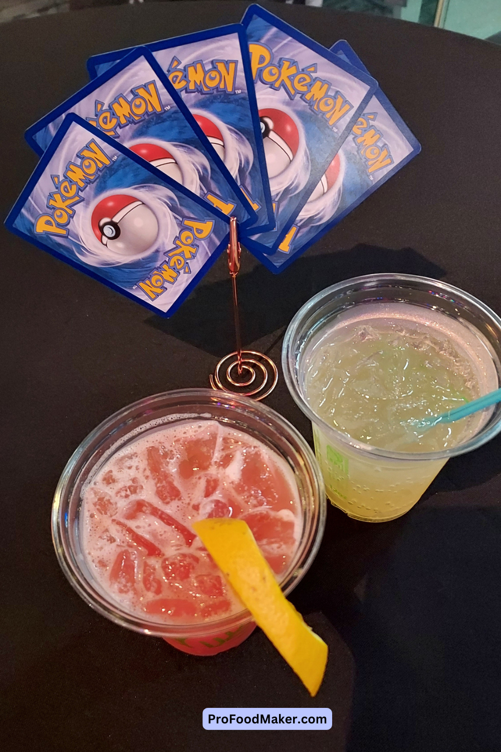 adult nights anime drink next to a stand of Pokemon cards