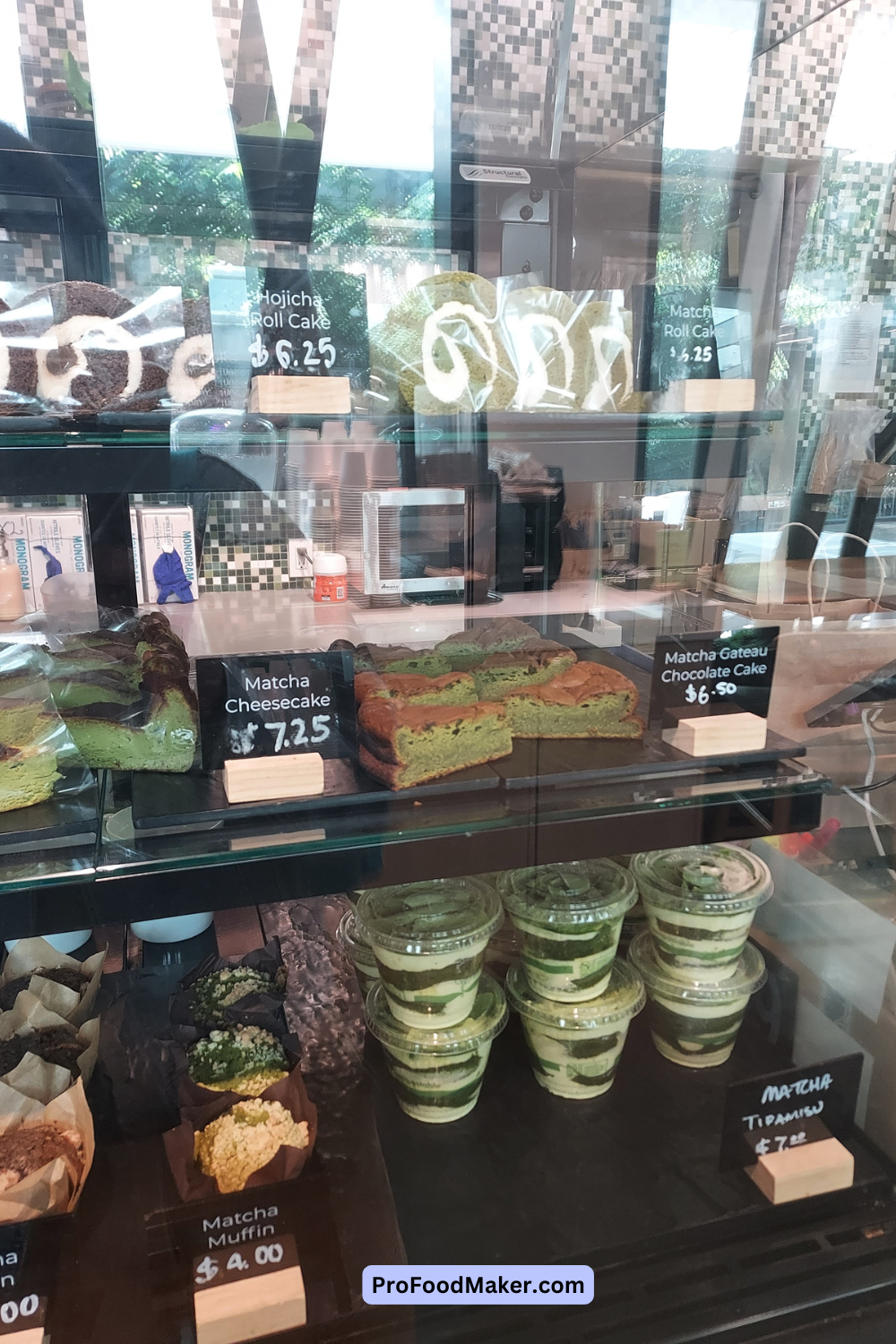 matcha cheesecake and other desserts in a black and clear display case near the register