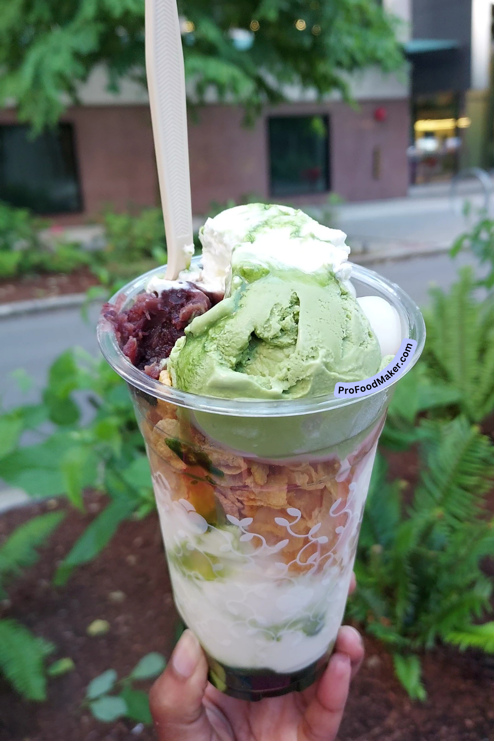 matcha parfait held in one hand outside in seattle