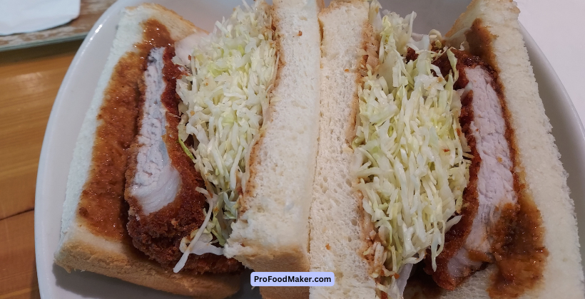 seattle tonkatsu sandwich cut in half on a white plate